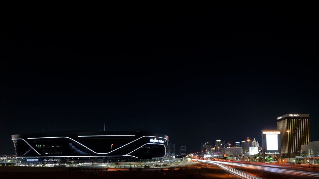 Allegiant Stadium and the Las Vegas skyline at night