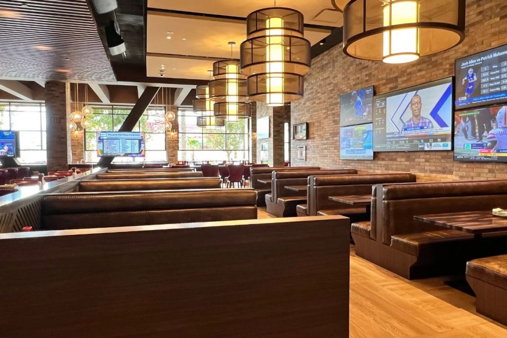 Booth seating and televisions inside Chickie’s and Pete’s at SAHARA Las Vegas