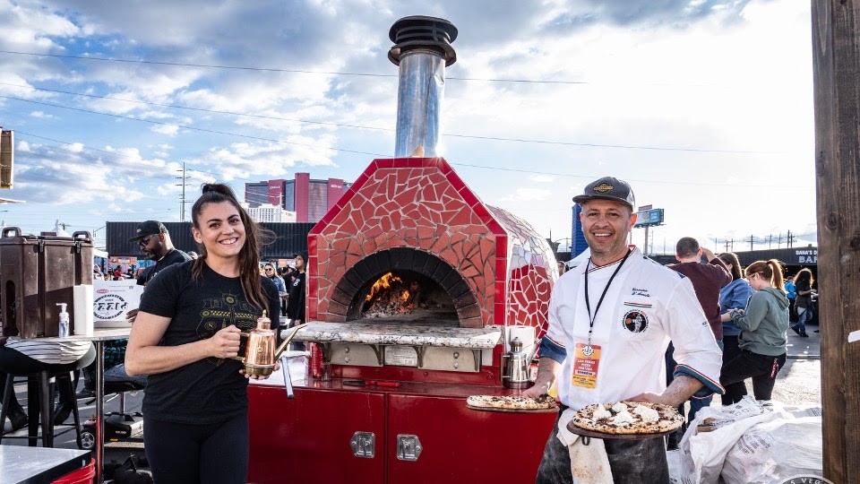 Pizza makers beside a wood fired oven at Las Vegas Pizza Festival