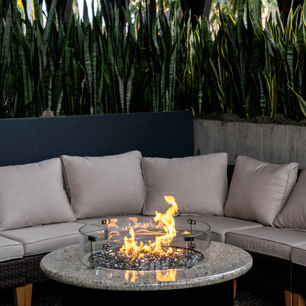 Outdoor seating and fire feature shown on the official Flecha Cantina website